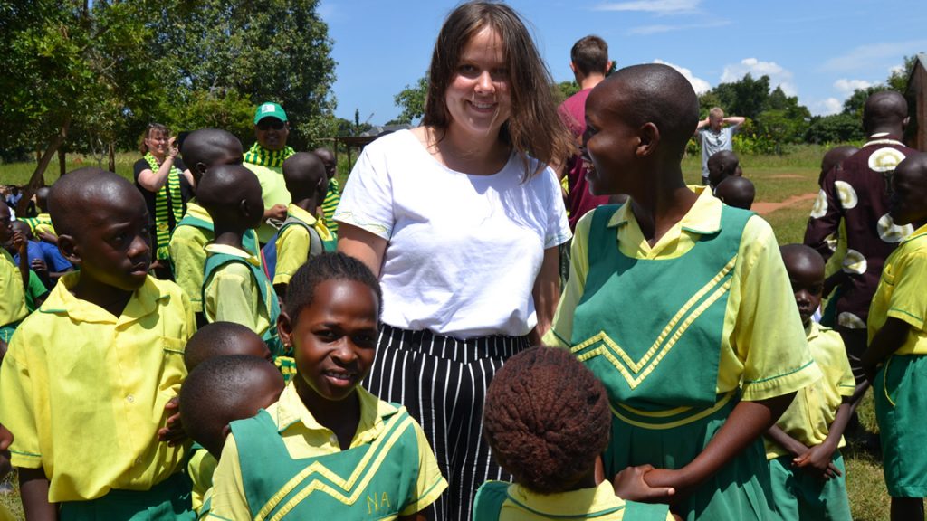 Anna, daughter of one of our customers, with the children from Child Africa's schools at the equator. 180703